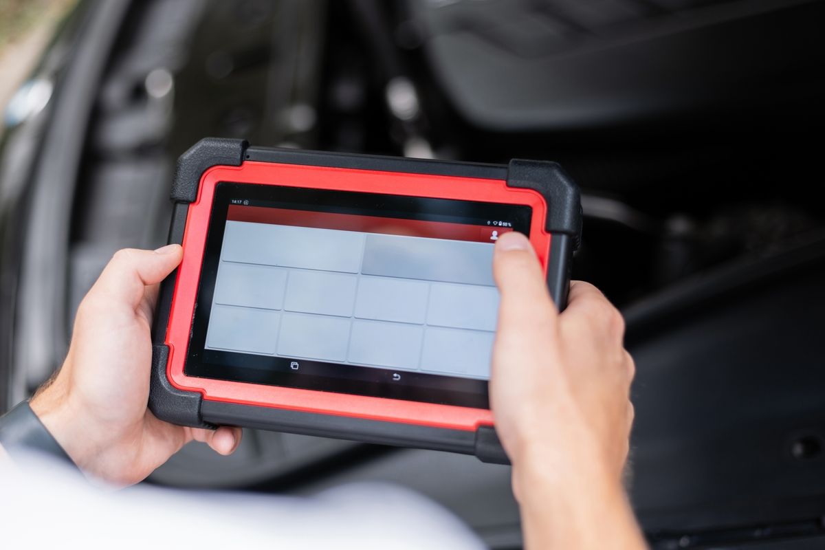 Technician performing OBD-II emissions test